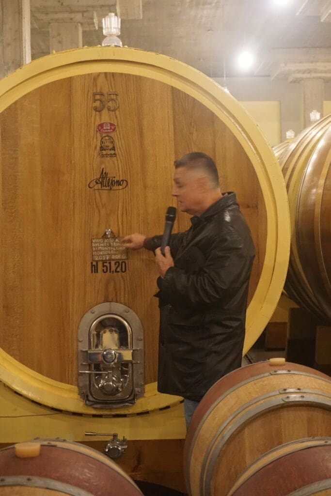 Inside the Altesino cellar with oak barrels for aging Brunello