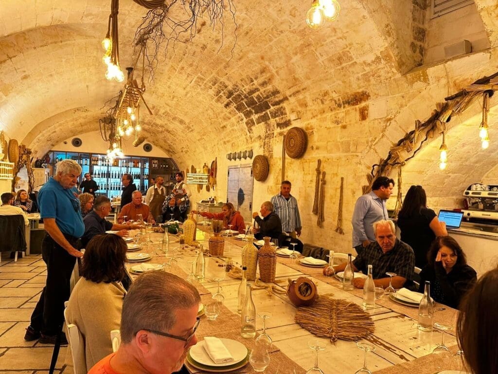 VIP Winery Vacations tour group at authentic Puglian winery in traditional stone cellar