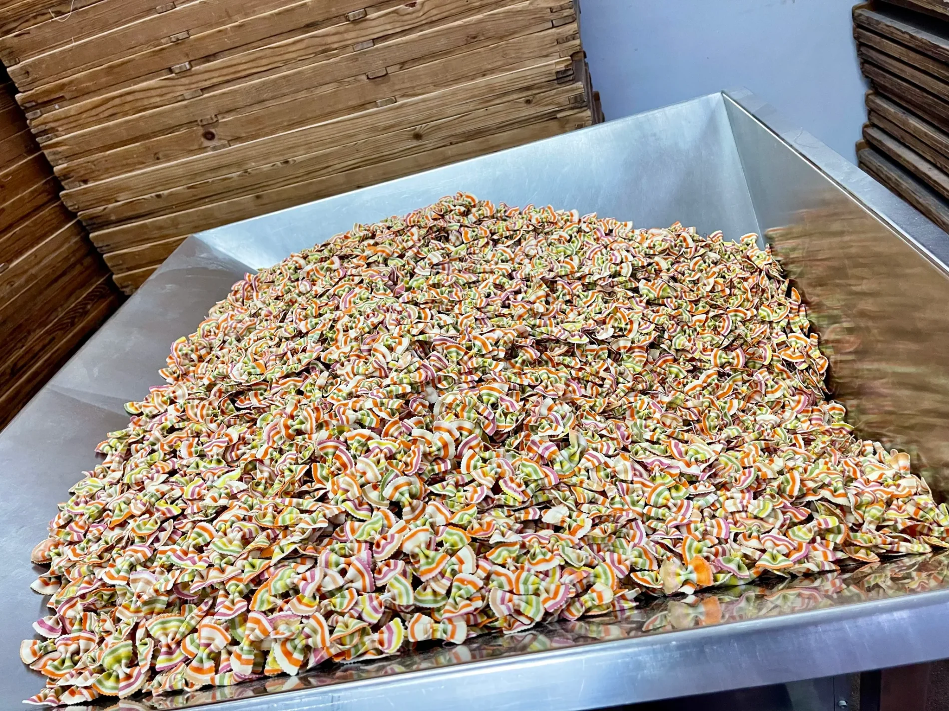 Colorful striped farfalle pasta in a metal container at Pastificio de Colle.